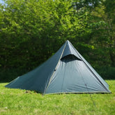 DD Superlight Pathfinder Tent set up in a green meadow, showcasing its spacious design for camping adventures.